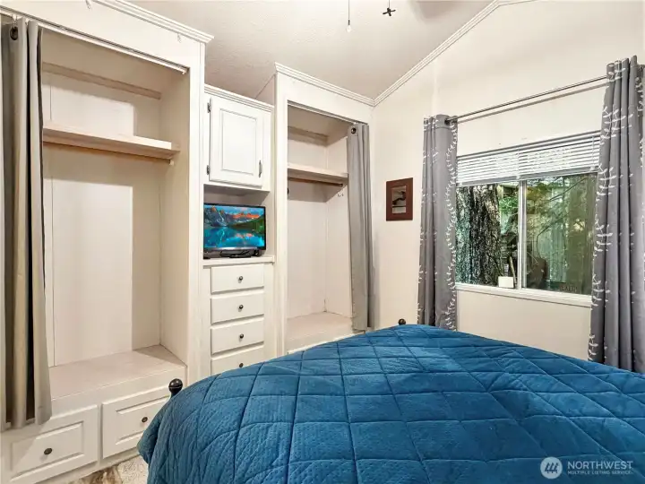 Built in dresser and large closets with curtain closures.