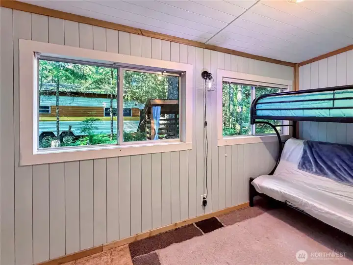 The addition has large windows and a twin over full bunk bed that is also a futon.