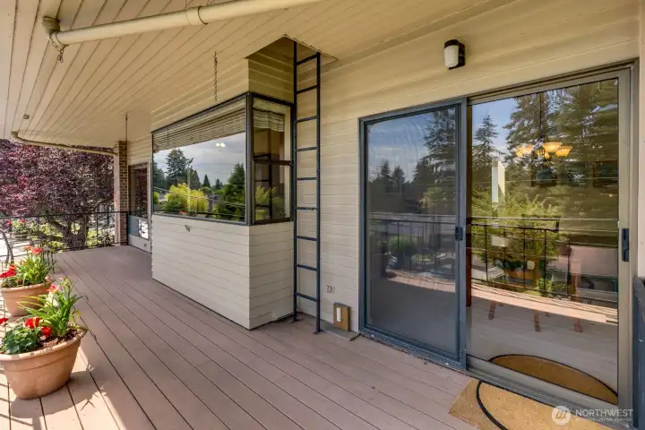 view of deck reflecting the huge garden window in the kitchen and sliders to dining on the right. view of deck reflecting the huge garden window in the kitchen and sliders to dining on the right.