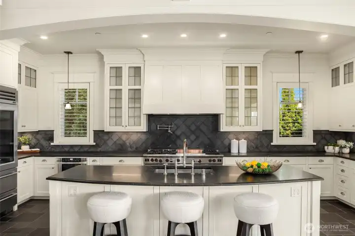 Everyone wants to gather here in this Epicurean's Dream kitchen that shines boldly with its massive island, custom leaded glass cabinetry and the mack daddy of Bosch stoves: the 6 burner with double ovens + a griddle and grill. Everyone wants to gather here in this Epicurean's Dream kitchen that shines boldly with its massive island, custom leaded glass cabinetry and the mack daddy of Bosch stoves: the 6 burner with double ovens + a griddle and grill.