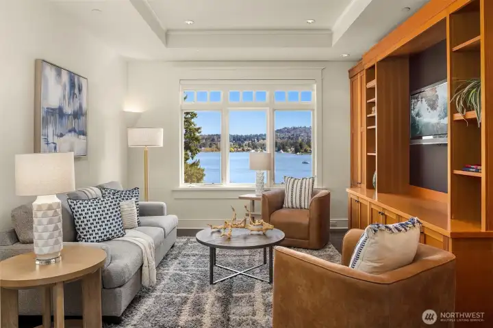 Step off the bonus room into a handsome TV space, where custom built-in cabinetry and sweeping views create a refined place to unwind. Step off the bonus room into a handsome TV space, where custom built-in cabinetry and sweeping views create a refined place to unwind.