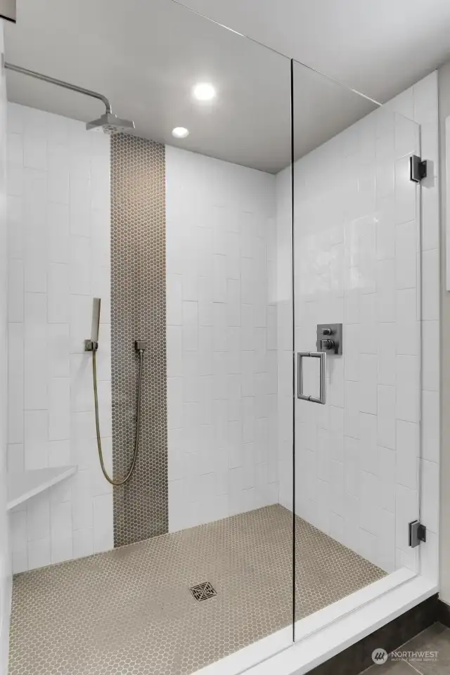 Filled with extensive designer tile and high end Delta hardware, this shower in the downstairs guest bedroom does not disappoint. The sleek glass swing door and radiant heated file flooring continues to showcase the details this home offers for the new owners.