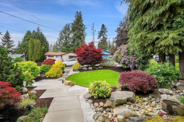This view from the front door shows off the new sidewalk, new lawn and gorgeous landscaping featuring many of our favorite Northwest plantings.  Don't miss the stone water fountain to the right.