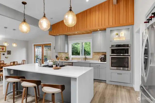Revel in this spacious and inviting chef's kitchen where the quartz waterfall island, LG stainless appliances (gas cook top, French door fridge and built-in oven and microwave) and extensive cabinetry envelope you as you create your culinary delights.