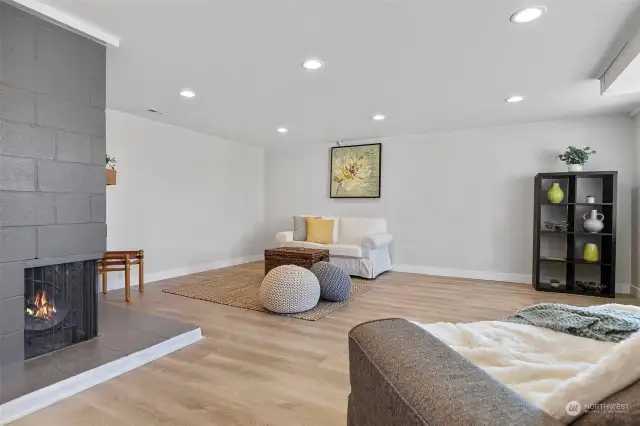 Downstairs living space with corner wood burning fireplace