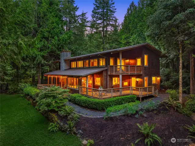 Down a long quiet lane on a a secluded 5-acre lot this beautiful home is surrounded by a canvas of green forestland.