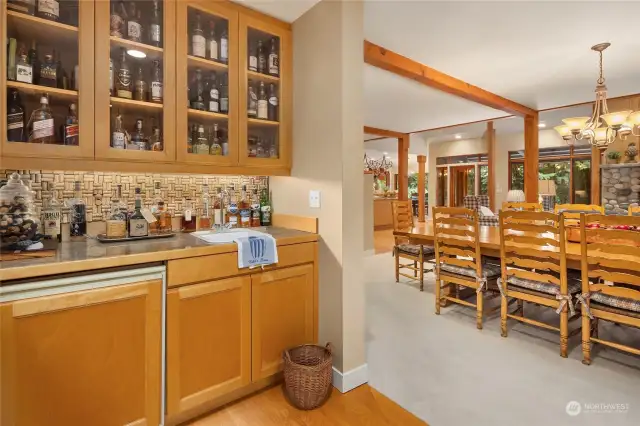 Wow, convenient to the dining area is this fantastic open wet bar with upper cabinets and under counter lighting complete with a small refrigerator keeping your mixers cool.