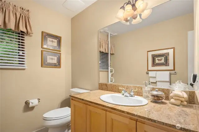 The main floor powder room is tucked off the back entry.