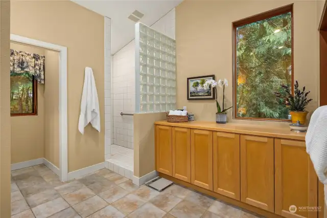 The Primary bath features sizeable storage, a spacious walk-in shower and heated tile floors.