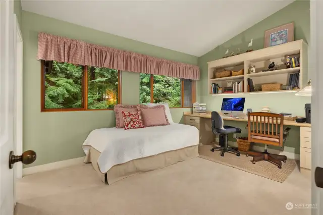 Bedroom # Three includes a beautiful built-in desk and shelving by California Closets.