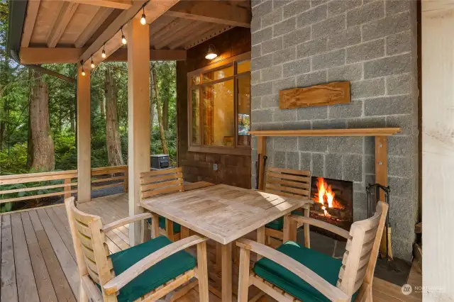 Outdoor wood-burning fireplace.  The expansive deck is crafted of durable Alaskan Yellow Cedar.