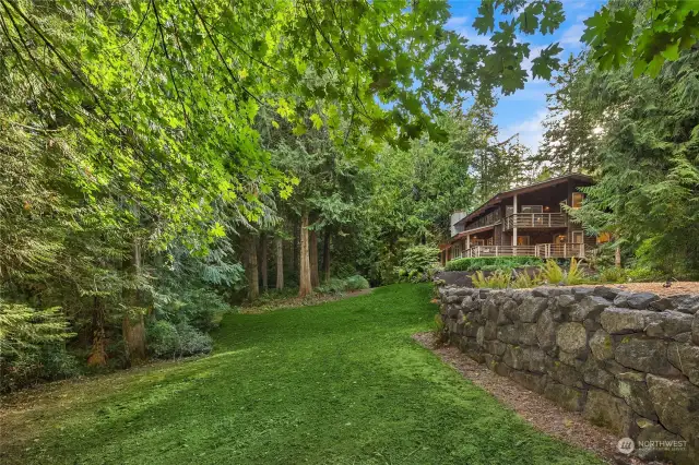 Basalt landscape garden walls frame the perimeter and driveway.