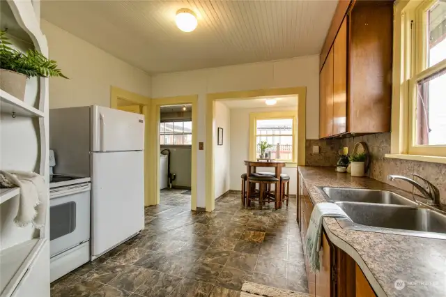 Large, sunny kitchen leads out to utility porch