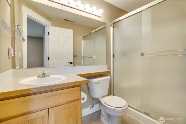 The primary bathroom has refreshed paint and a large walk-in shower too.