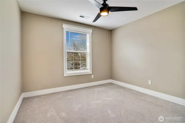 This upstairs bedroom features fresh paint, new carpet, and updated millwork, creating a bright and welcoming space ready for you to personalize and enjoy
