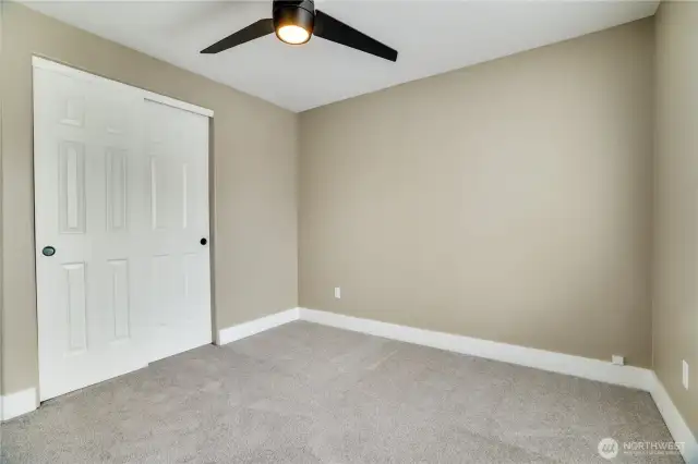 This bedroom not only offers refreshed charm with fresh paint, new carpet, and updated millwork, but also includes a generous closet, providing ample storage to keep everything organized and accessible