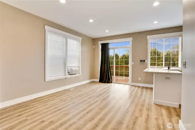 The expansive dining area and eat-in kitchen offer abundant space for hosting memorable gatherings. Step through the sliding door onto the deck, where you'll discover the newly terraced back yard, perfect for outdoor enjoyment and exploration.