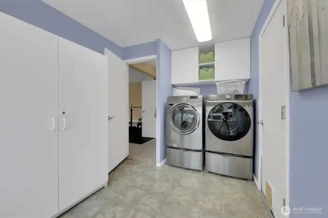 Large laundry room with built in storage.