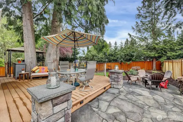 Stone patio/ firepit area extends outdoor living and entertaining.