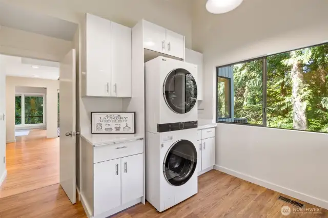 Oversized laundry room with sink and new cabinets.