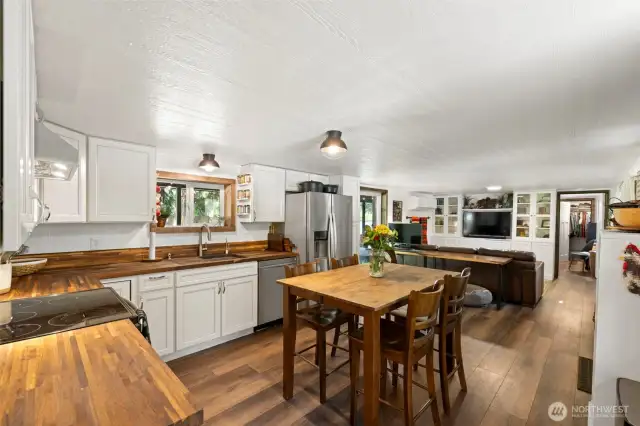 Charming kitchen with butcher block counters, space for dining, and a cleverly designed floor plan that maximizes function and flow.
