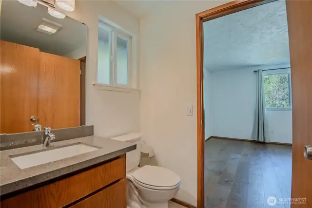Full bath with tub/shower - off one of the main level bedrooms w/ access from laundry room
