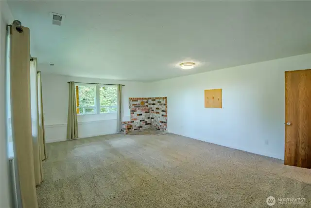 Lower level 2nd living room with brick surround should you want to put in a new wood stove for cozy nights by the fire