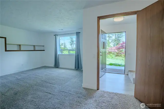 Family room on the lower level with access out to the garden space.