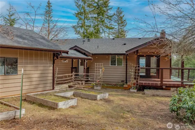 More garden space behind the home/garage with covered patio off the dining space that wraps around to the spacious deck to take advantage of those incredible Hood Canal and moutntain Views