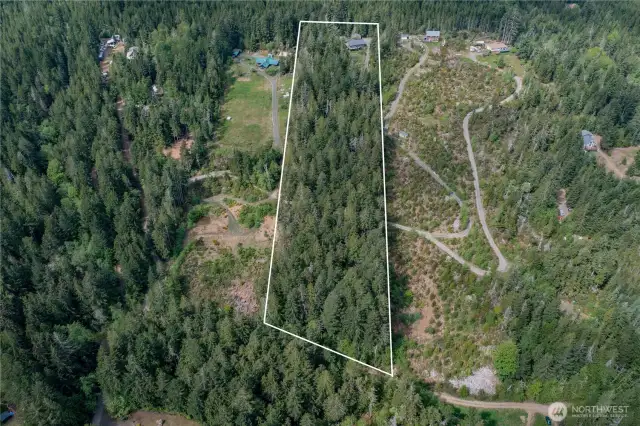 Over 5 acres of land with plenty of opportunity to open up the trees to control the water/mountain views!