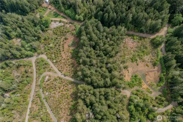 The access road cuts through the lot - with a lower road access for two points of entry to the lower level of the land.