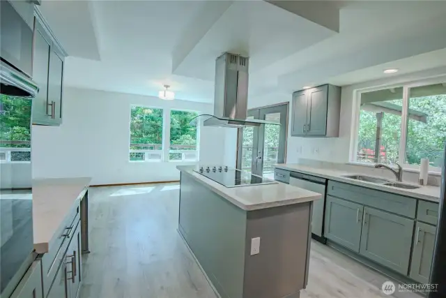 Spacious kitchen island with stovetop and overhead vent