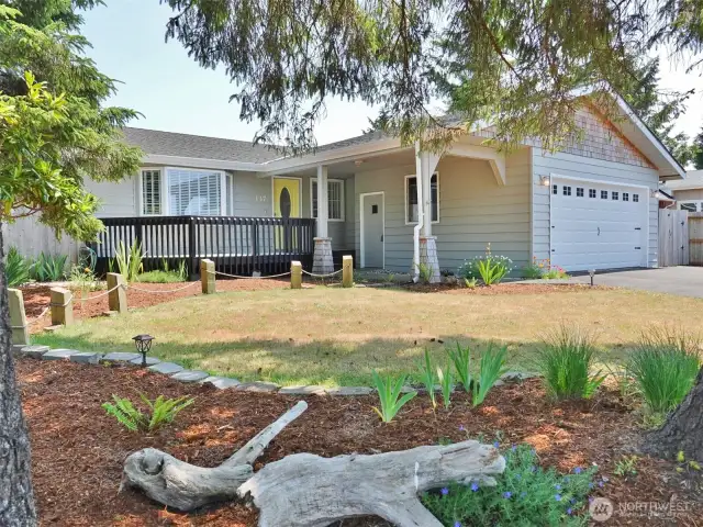 Front of the home w/ landscaped front and back yards.