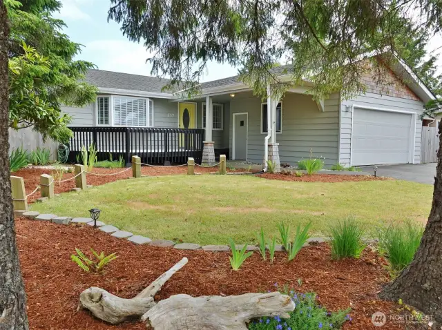 Front of the home w/ landscaped front and back yards.