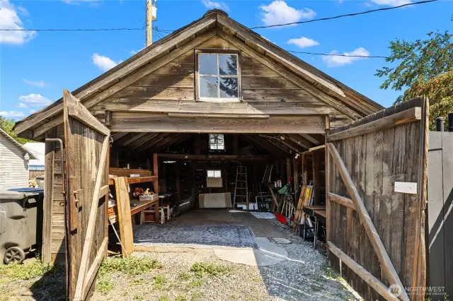 280 sq ft garage with shelving and loft storage space.