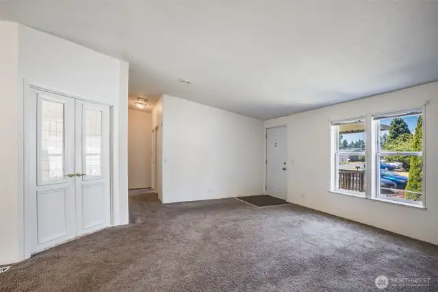This cozy living room with double doors leads to a perfect home office, guest room, or creative space.