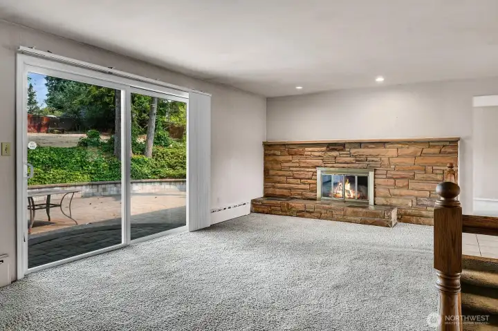 Large living room with brick wood burning fireplace.
