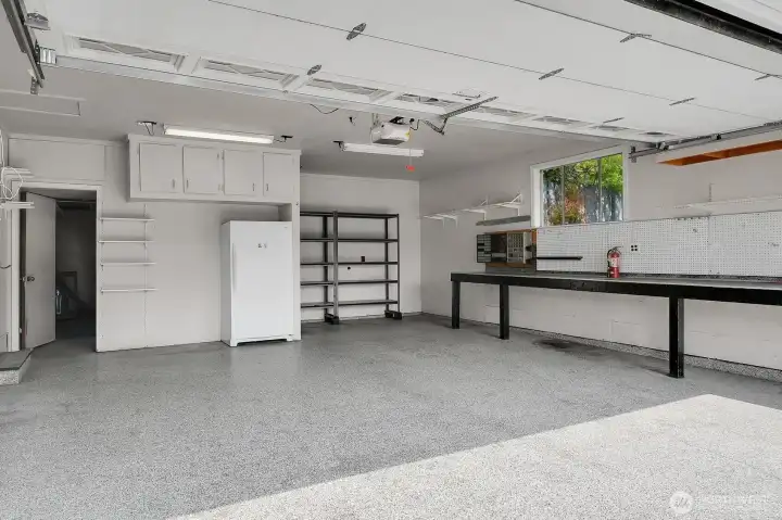 Awesome 2+ car garage with workshop bench and storage.