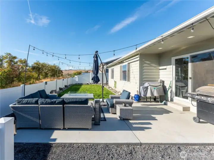 oversized patio with fenced backyard