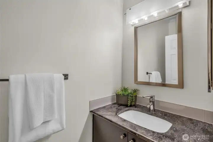 Powder room with granite counters.