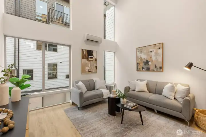 Soaring ceilings and a mezzanine-level overlook define this light-filled, open-concept main floor.