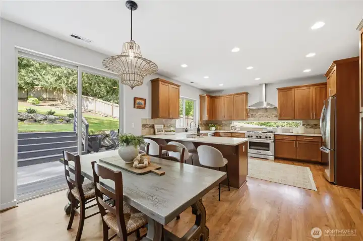 Looking toward the dining area and the kitchen - with step out to the spacious deck outside.