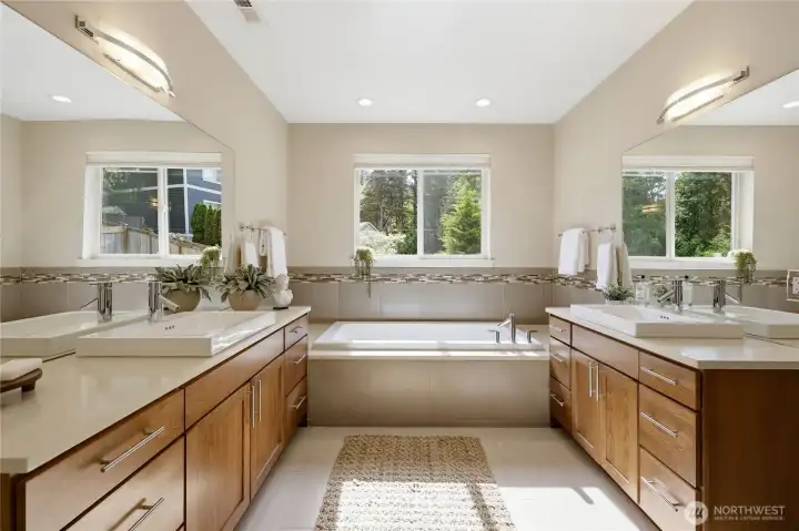 Well lit and private bathroom with separate cabinetry/sink.