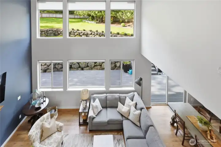 View of the greatroom, windows and yard from the loft