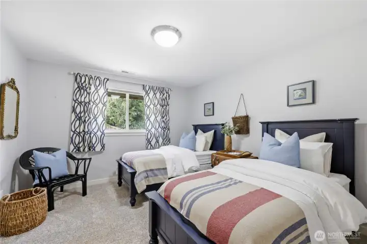 This bedroom has a large walk-in closet and looks out to the backyard