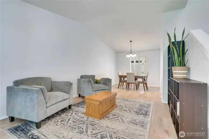 Step inside to the light and bright living room with laminate floors, vaulted ceilings and easy movement to the dining space and kitchen.