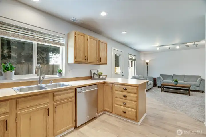 The kitchen sink overlooks the lush backyard - a calming view while creating meals and winding down at the end of the day. The dishwasher is less than a year old, so let it take on that stack of dishes in the sink while you relax in the family room.