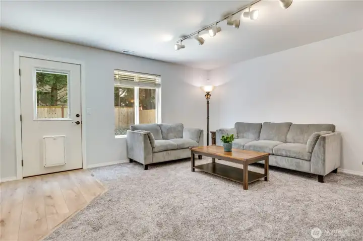 Quick access to the backyard is through the oversized door pictured here. The natural light gleams through the back door and window, but don't worry, both have blinds in case you need them!