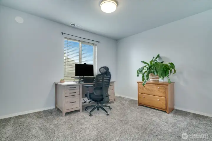 The sizable main floor bedroom (currently used as an office) features newer carpet and has a double-door closet. Easy access to the half bath just down the hall!