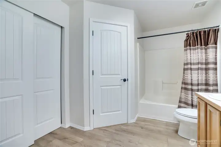 Store linens, towels or more of your wardrobe in the additional closet in this bathroom!